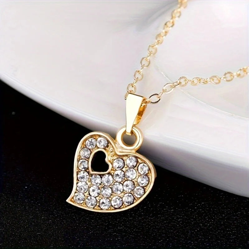 A 4-piece fashion jewelry set that includes rhinestone jewelry, including peach heart pendant necklaces, rings, studs, and bracelets, perfect for everyday wear or parties. mbzr