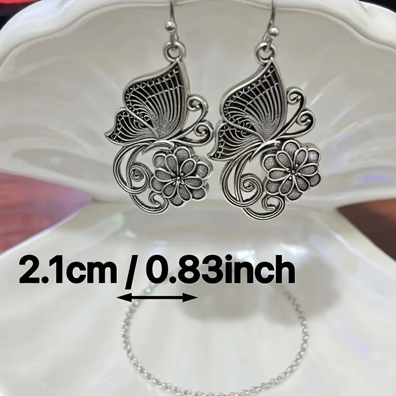 Vintage Bohemian style heavy metal hollowed out carved butterfly flower hanging earrings, integrating ethnic flower design with unique personality, versatile for daily use in spring, and preferred for women's high-end earring
