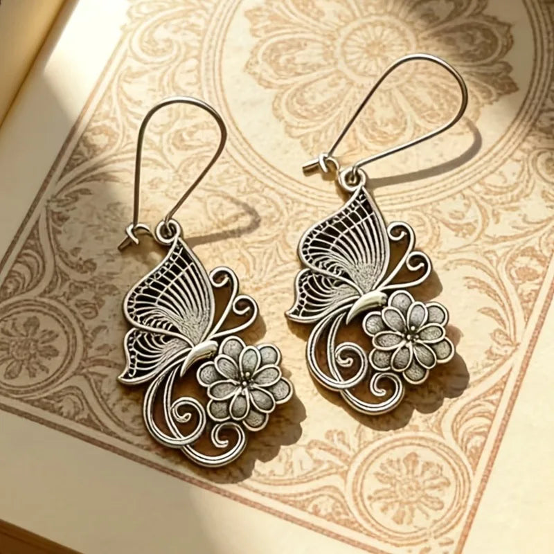 Vintage Bohemian style heavy metal hollowed out carved butterfly flower hanging earrings, integrating ethnic flower design with unique personality, versatile for daily use in spring, and preferred for women's high-end earring