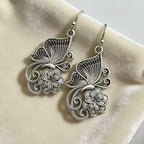 Vintage Bohemian style heavy metal hollowed out carved butterfly flower hanging earrings, integrating ethnic flower design with unique personality, versatile for daily use in spring, and preferred for women's high-end earring